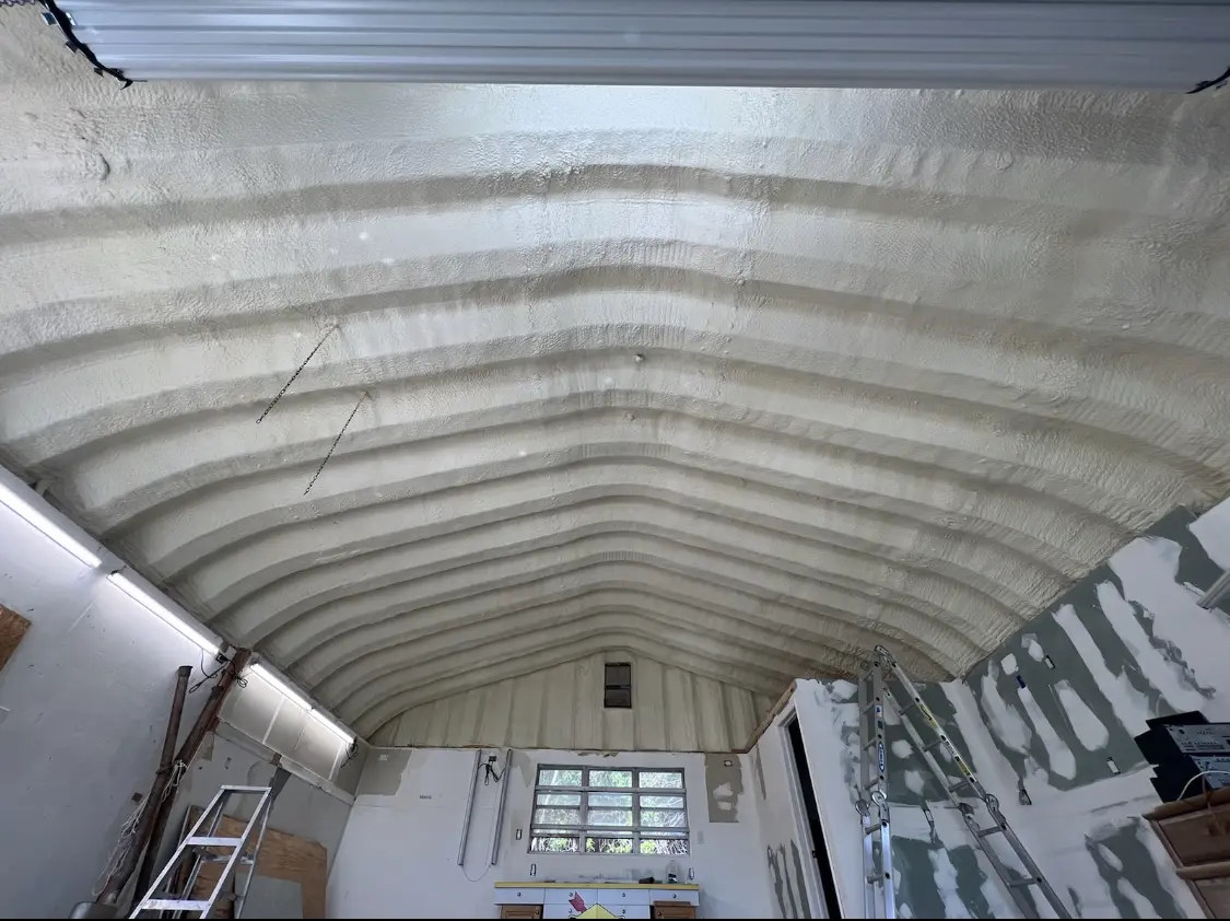 Spray polyurethane foam applied to the underside of a metal roof deck in Macedon